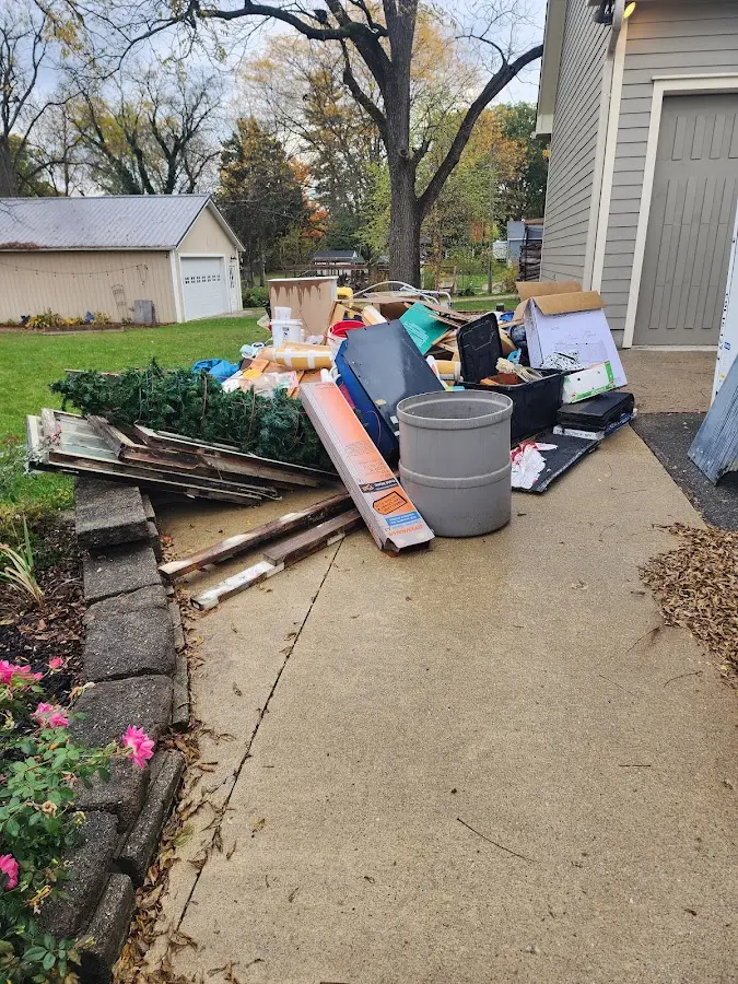 Dumpster being loaded with debris for Estate Cleanout Dumpster Rental in Campbell